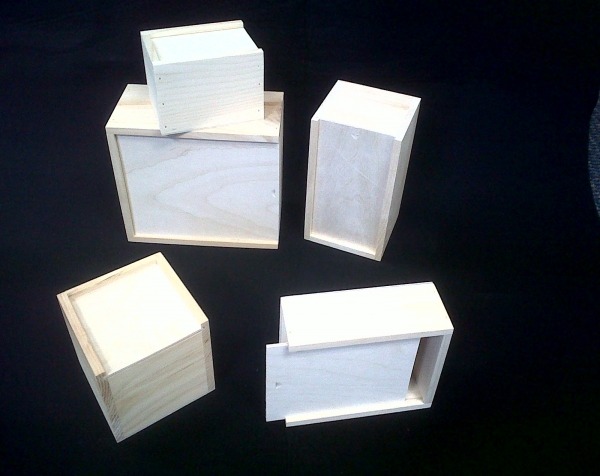 Assorted custom slide-top wooden boxes in various sizes, designed for corporate gifts, packaging, and promotions.